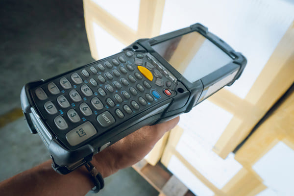 A closeup of a mobile computer scanning a box barcode