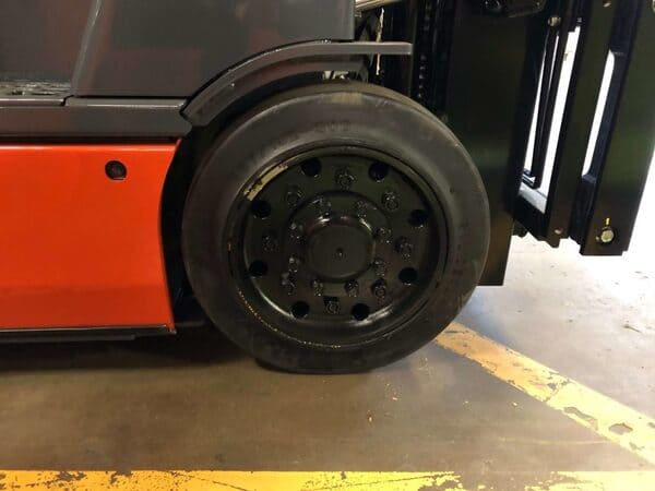 A close-up of a cushion tire on a Toyota 4-wheel electric forklift