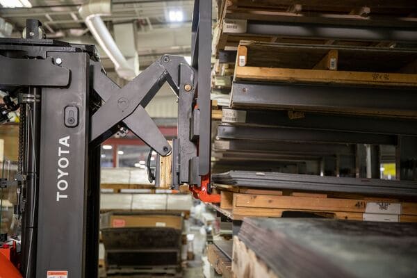 A Toyota reach truck retrieving a pallet from warehouse pallet racking