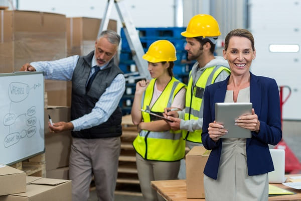 A warehouse supervisor giving a presentation to workers