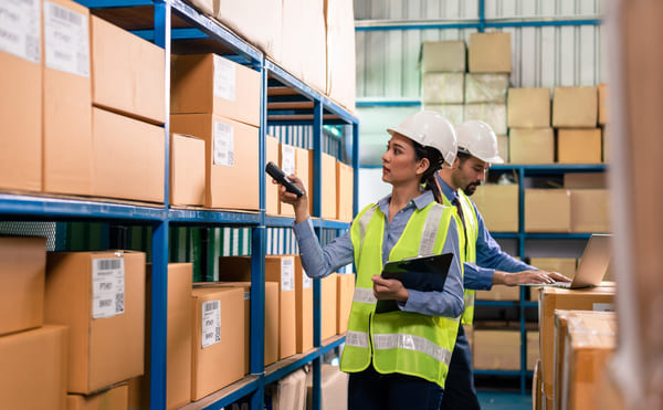 Warehouse workers scanning barcodes on boxes