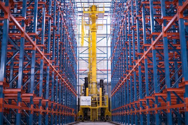 A Bastian Solutions automated crane in an aisle in a warehouse