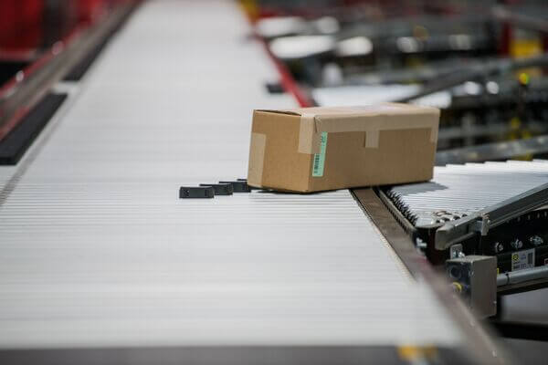 A cardboard box coming down a conveyor line