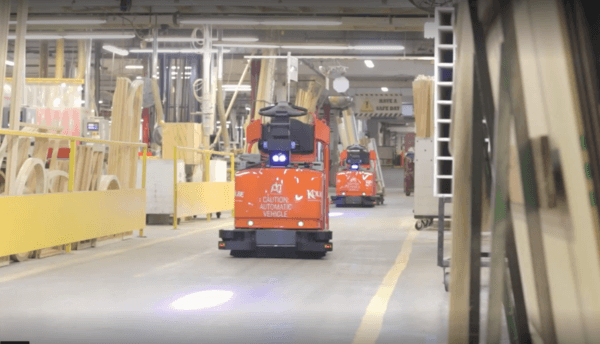 Toyota automated guided vehicle (AGV) tow tractors running down an aisle in Kolbe Windows & Doors' facility