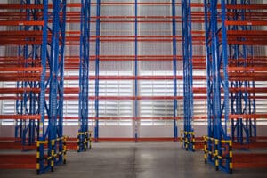 An empty warehouse with rows of unused pallet racking