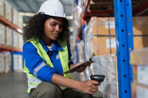 Warehouse worker scanning boxes in a warehouse