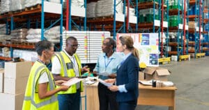 A group of warehouse workers holding a discussion