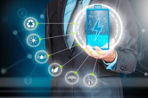 A person in a business suit pointing at an energy efficiency sign