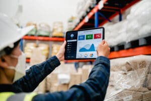 A warehouse manager using a tablet to manage their warehouse