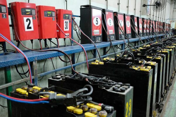 A bank of lead-acid forklift batteries on charge
