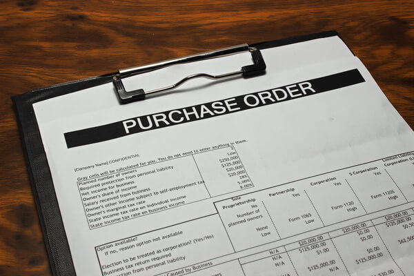 A purchase order form on a clipboard