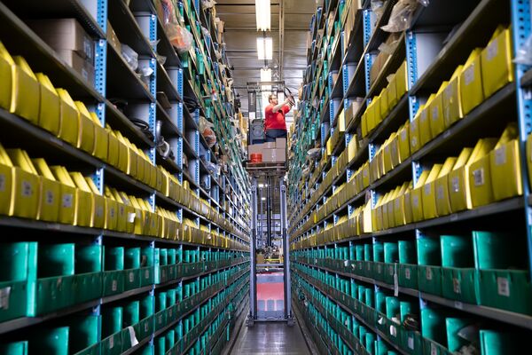 A Toyota order picker operating in a very narrow aisle