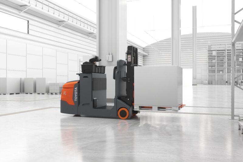 A Toyota center rider stacker forklift lifting a pallet in a simulated warehouse