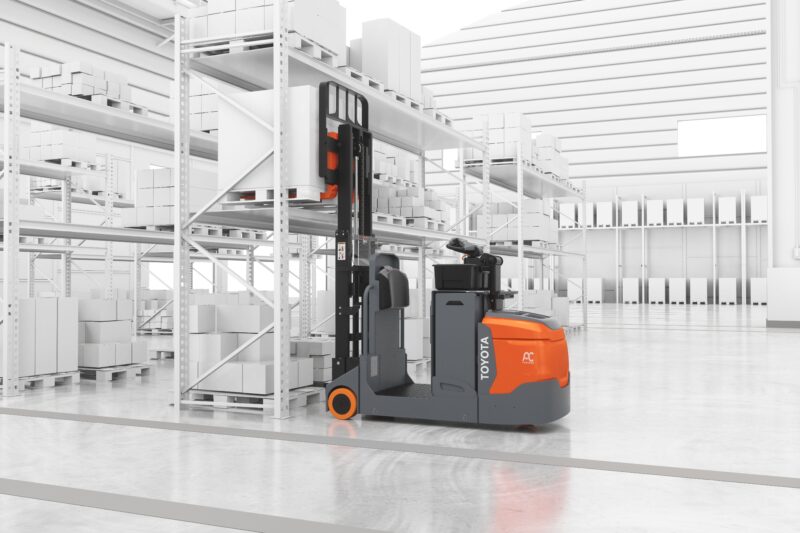 A Toyota center rider stacker forklift placing a pallet in pallet racking in a simulated warehouse