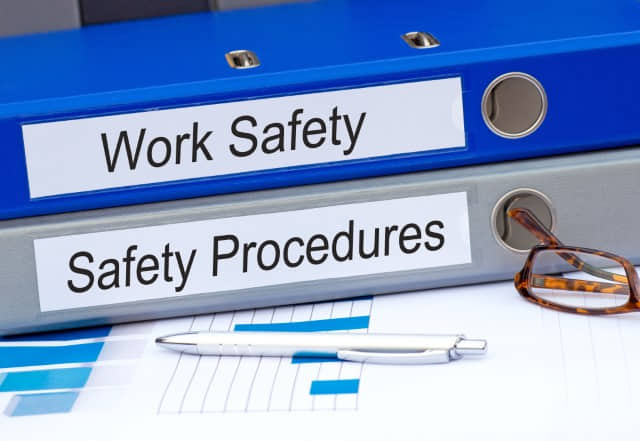 Work Safety and Safety Procedures binders on a desk