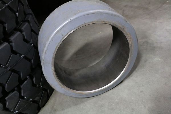 A smooth, gray polyurethane forklift tire