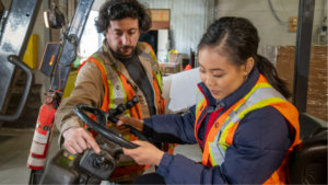 Instructor explaining the process of operating a forklift
