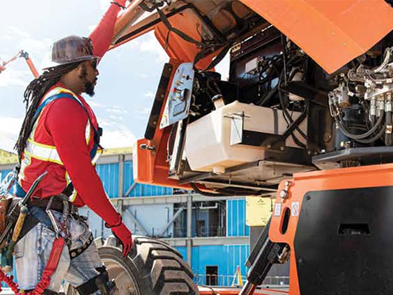 Equipment tech working on a JLG boom lift