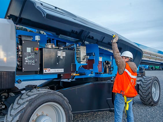 Equipment tech working on a genie boom lift